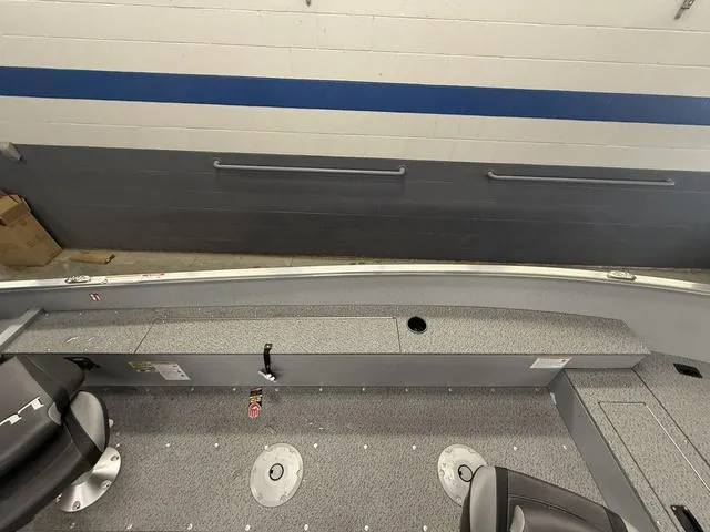 Slide: The Image of 2025 Lund 1600 Fury Tiller boat interior with seating and storage compartments. - 15