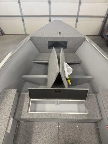 Slide: The Image of 2025 Lund 1600 Fury Tiller boat interior with storage compartments and seating. - 18