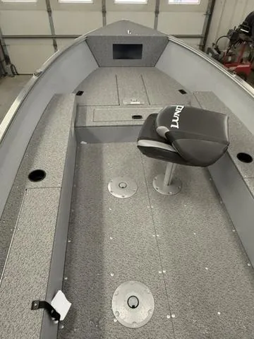 Slide: The Image of 2025 Lund 1600 Fury Tiller boat interior with gray seating and storage compartments. - 8