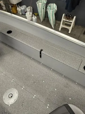 Slide: The Image of 2025 Lund 1600 Fury Tiller boat interior with storage compartment and clean deck. - 9