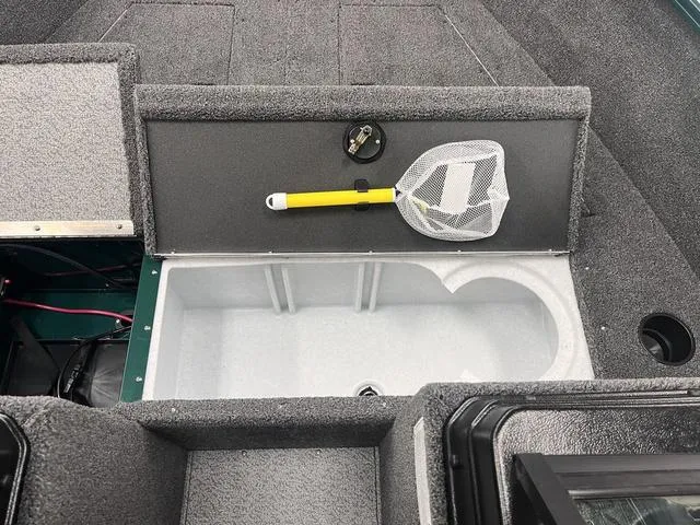 Slide: The Image of 2025 Lund 1650 Rebel XL Sport boat interior with storage compartment and fishing net. - 12