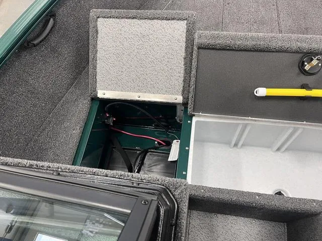 Slide: The Image of 2025 Lund 1650 Rebel XL Sport boat interior with storage compartments and wiring. - 13