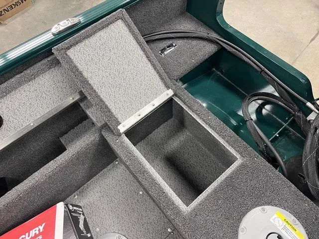 Slide: The Image of 2025 Lund 1650 Rebel XL Sport boat interior with open storage compartment. - 17