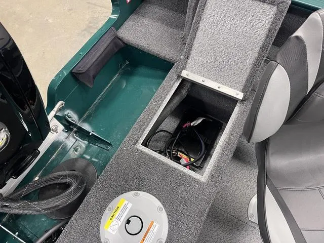 Slide: The Image of 2025 Lund 1650 Rebel XL Sport boat interior with storage compartment and seating. - 28