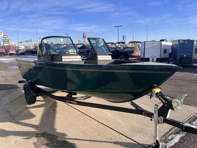 Slide: The Image of 2025 Lund 1650 Rebel XL Sport boat on trailer, parked outdoors under clear blue sky. - 6