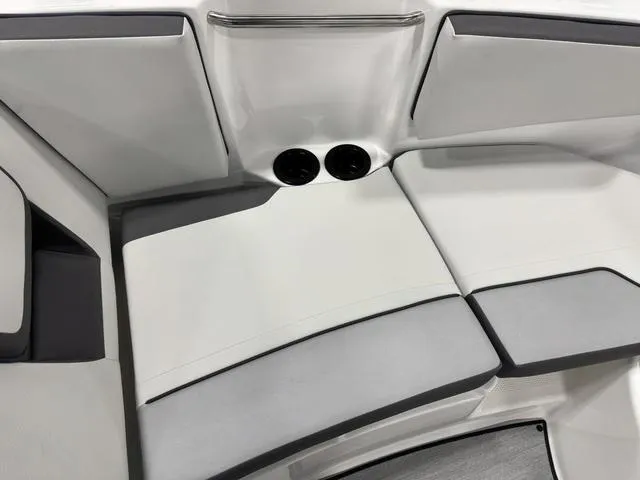 Slide: The Image of 2025 Yamaha Boats AR220 interior seating with sleek, modern design and comfortable cushions. - 18