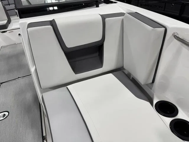 Slide: The Image of 2025 Yamaha Boats AR220 interior seating with modern design and cup holders. - 25