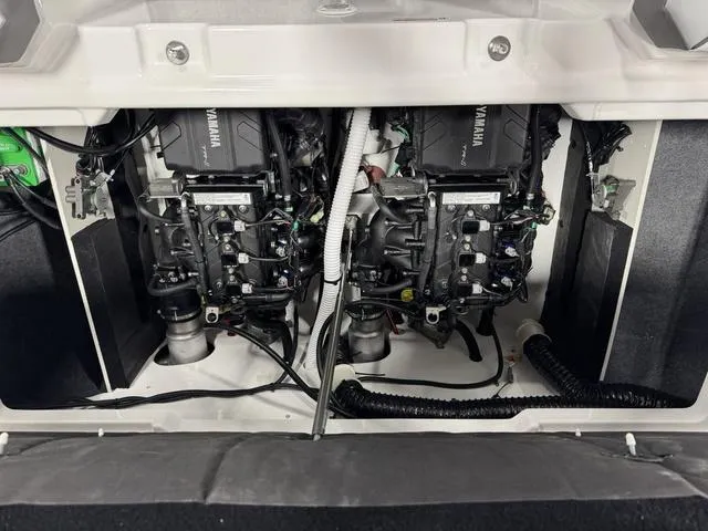 Slide: The Image of 2025 Yamaha AR220 boat engine compartment with dual engines and wiring. - 26