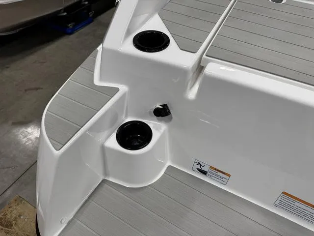 Slide: The Image of 2025 Yamaha Boats AR220 deck with cup holders and non-slip surface. - 27