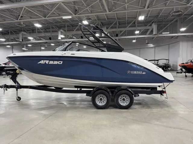 Slide: The Image of 2025 Yamaha Boats AR220 displayed indoors on a trailer. - 28