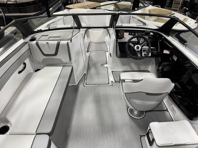 Slide: The Image of 2025 Yamaha Boats AR220 interior with sleek seating and modern dashboard design. - 4
