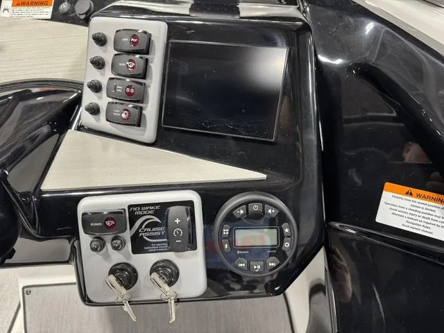 Slide: The Image of Control panel of 2025 Yamaha Boats AR220 with switches and display screen. - 5
