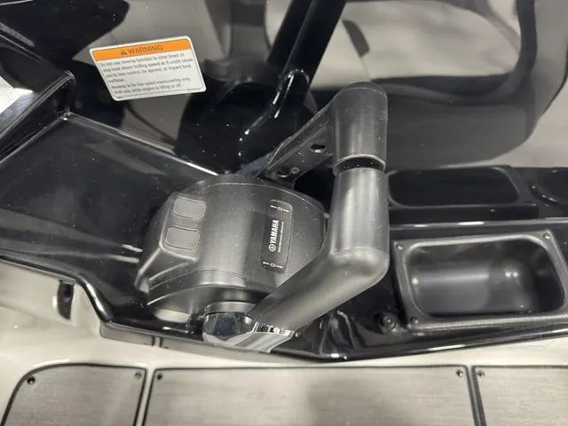 Slide: The Image of Throttle control of 2025 Yamaha Boats AR220, featuring sleek black design and ergonomic handle. - 6