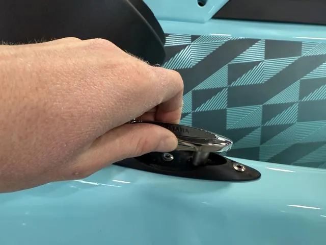 Slide: The Image of Hand operating cleat on 2025 Yamaha Waverunner VX® Limited HO, turquoise design. - 17