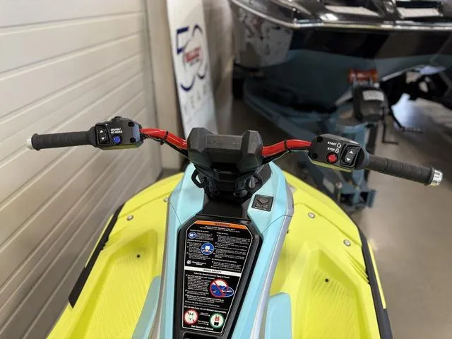 Slide: The Image of 2025 Yamaha Waverunners Jetblaster handlebars, vibrant yellow and blue design, indoor display. - 18