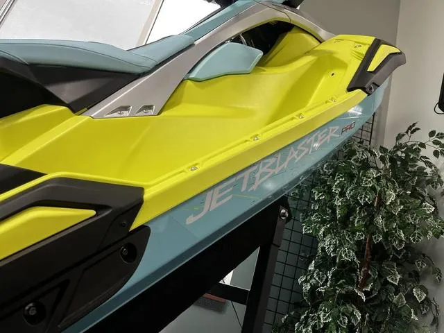 Slide: The Image of 2025 Yamaha Waverunner Jetblaster in vibrant yellow and blue, displayed indoors. - 5