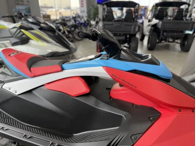 Slide: The Image of 2025 Yamaha Waverunner Jetblaster DLX 2-Up in showroom, vibrant red and blue design. - 14