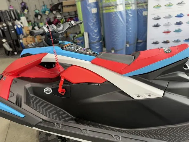 Slide: The Image of 2025 Yamaha Waverunner Jetblaster DLX 2-Up in showroom, vibrant red and blue design. - 9