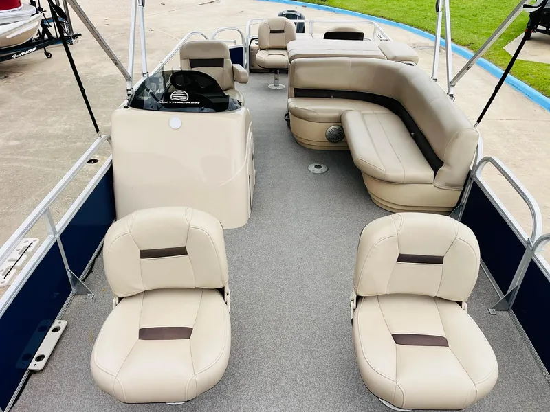 Slide: The Image of 2017 Sun Tracker Fishin' Barge 22 XP3 interior with beige seating and steering console. - 10
