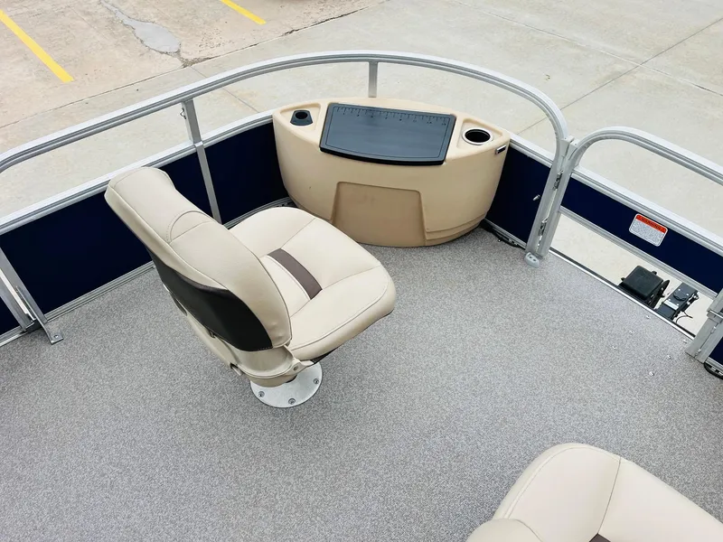 Slide: The Image of 2017 Sun Tracker Fishin' Barge 22 XP3 boat interior with seating and control panel. - 13