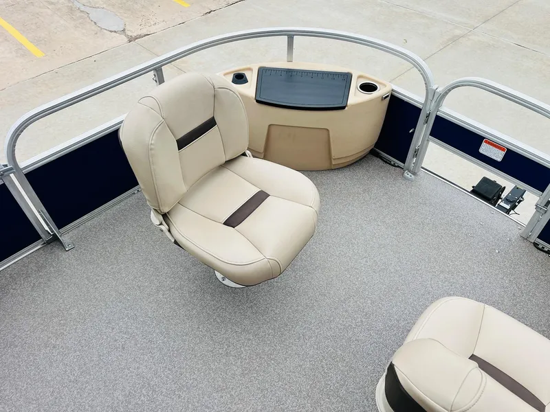 Slide: The Image of 2017 Sun Tracker Fishin' Barge 22 XP3 boat interior with beige seating and console. - 14