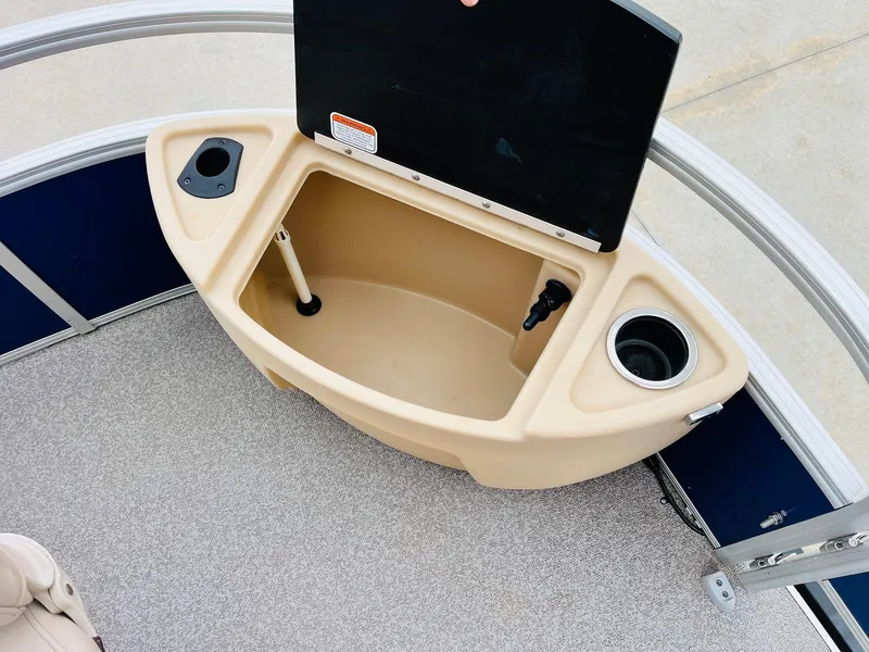 Slide: The Image of 2017 Sun Tracker Fishin' Barge 22 XP3 boat storage compartment with cup holders. - 15