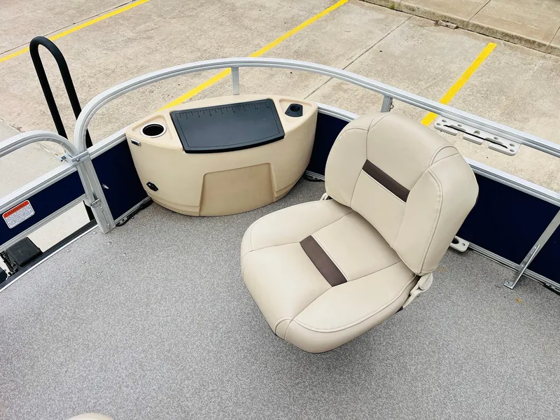 Slide: The Image of 2017 Sun Tracker Fishin' Barge 22 XP3 boat with beige seating and storage area. - 17