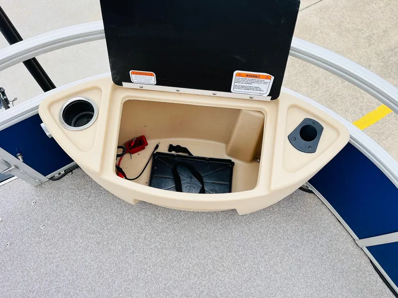 Slide: The Image of 2017 Sun Tracker Fishin' Barge 22 XP3 storage compartment with cup holders and accessories. - 18