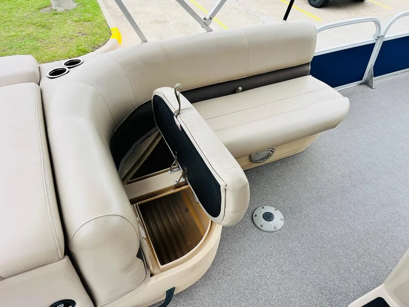 Slide: The Image of 2017 Sun Tracker Fishin' Barge 22 XP3 with open storage under beige seating. - 23