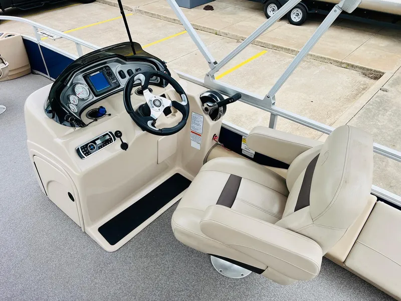 Slide: The Image of 2017 Sun Tracker Fishin' Barge 22 XP3 helm with beige captain's chair and control panel. - 24