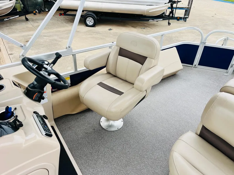 Slide: The Image of 2017 Sun Tracker Fishin' Barge 22 XP3 interior with beige captain's chair and steering console. - 25