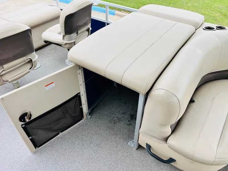 Slide: The Image of 2017 Sun Tracker Fishin' Barge 22 XP3 interior with beige seating and storage compartment. - 31