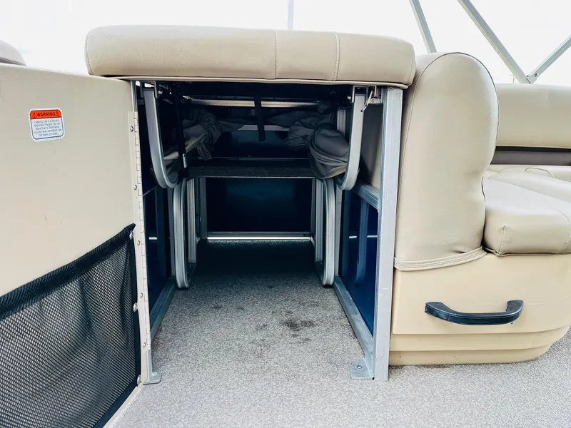 Slide: The Image of 2017 Sun Tracker Fishin' Barge 22 XP3 interior storage space with beige seating. - 32