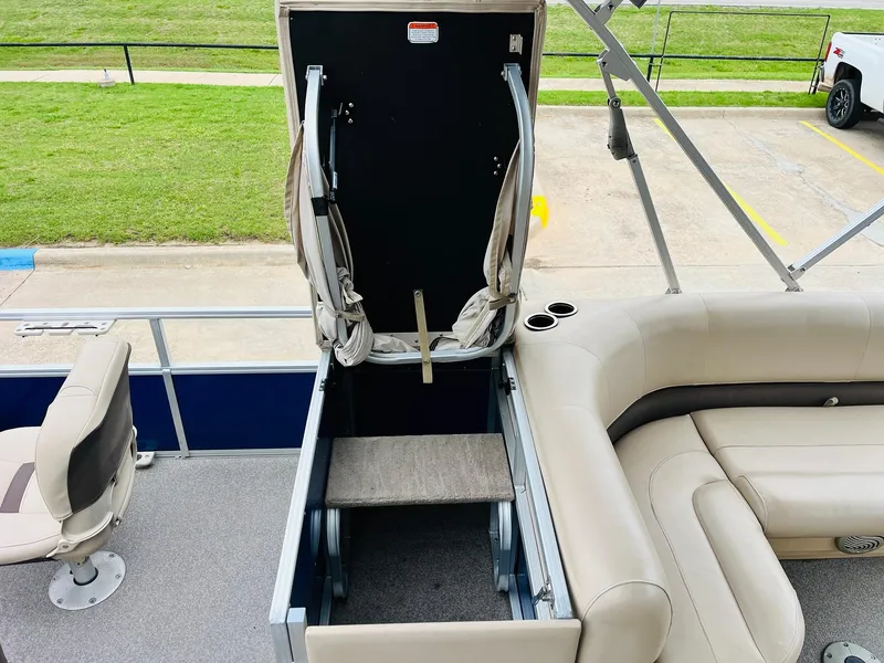 Slide: The Image of 2017 Sun Tracker Fishin' Barge 22 XP3 with open storage compartment and seating area. - 33