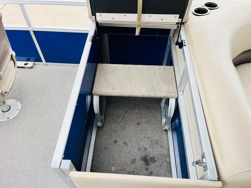 Slide: The Image of 2017 Sun Tracker Fishin' Barge 22 XP3 storage compartment with seating and cup holders. - 35
