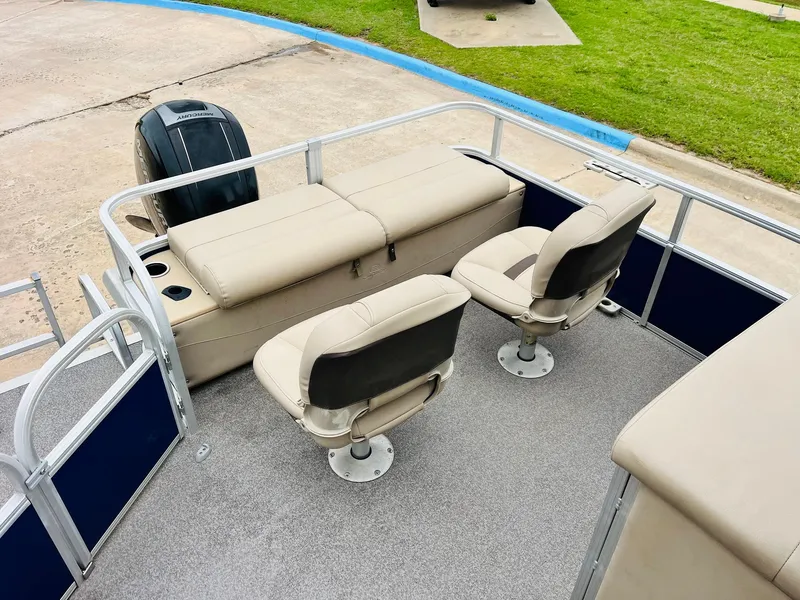 Slide: The Image of 2017 Sun Tracker Fishin' Barge 22 XP3 interior with seating and motor view. - 36