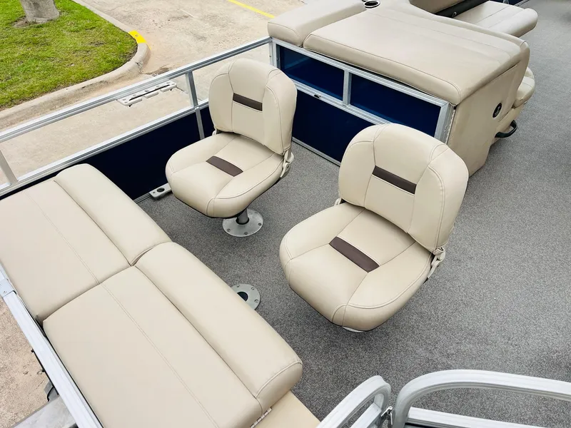 Slide: The Image of 2017 Sun Tracker Fishin' Barge 22 XP3 interior with beige seating and storage compartments. - 37