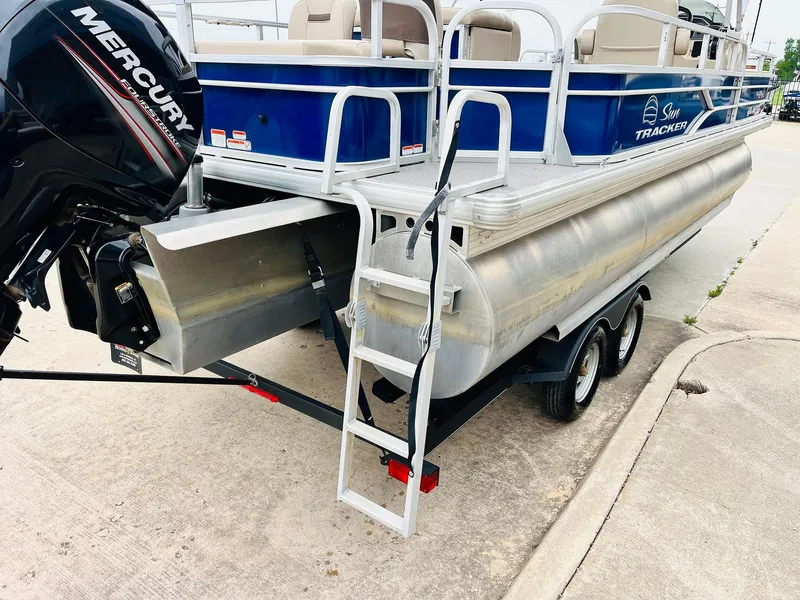 Slide: The Image of 2017 Sun Tracker Fishin' Barge 22 XP3 pontoon boat on trailer with Mercury outboard motor. - 9