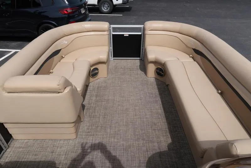 Slide: The Image of 2016 Bennington 22 SLX pontoon boat interior with beige seating and carpeted floor. - 11