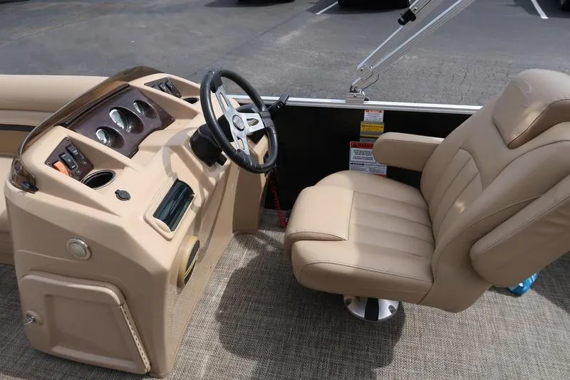 Slide: The Image of 2016 Bennington 22 SLX boat interior with beige captain's chair and control panel. - 13