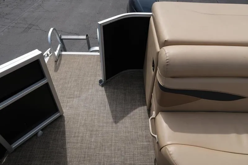 Slide: The Image of 2016 Bennington 22 SLX pontoon boat interior with beige seating and open gate. - 18