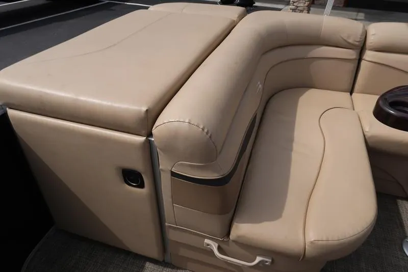 Slide: The Image of 2016 Bennington 22 SLX boat with beige leather seating and storage compartment. - 19