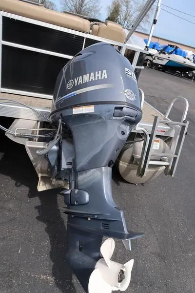 Slide: The Image of 2016 Bennington 22 SLX with Yamaha outboard motor, parked on pavement. - 4