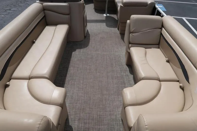 Slide: The Image of Luxurious interior of a 2016 Bennington 22 SLX pontoon boat with beige seating. - 7