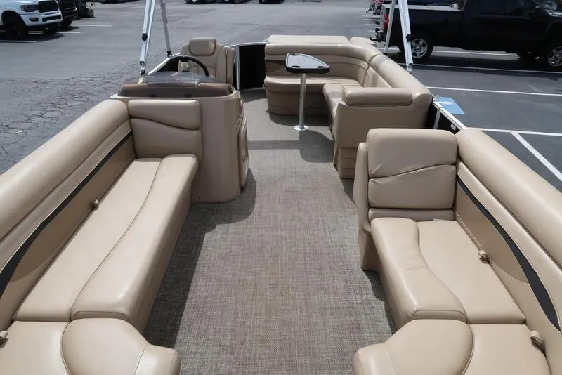 Slide: The Image of 2016 Bennington 22 SLX pontoon boat with spacious beige seating and modern interior design. - 8