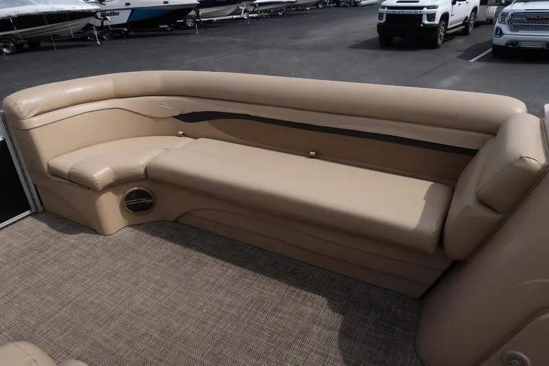 Slide: The Image of 2016 Bennington 22 SLX pontoon boat interior with beige seating and carpeted flooring. - 9