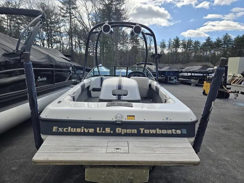 Slide: The Image of 2001 Malibu Sportster boat with "Exclusive U.S. Open Towboats" label, parked outdoors. - 11