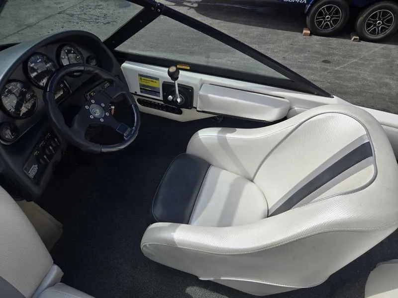 Slide: The Image of 2001 Malibu Sportster boat interior with steering wheel and white seating. - 13