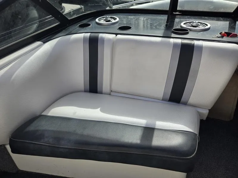 Slide: The Image of 2001 Malibu Sportster boat interior with white and black seating. - 14