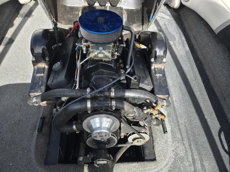 Slide: The Image of 2001 Malibu Sportster engine compartment with visible components and blue air filter. - 17
